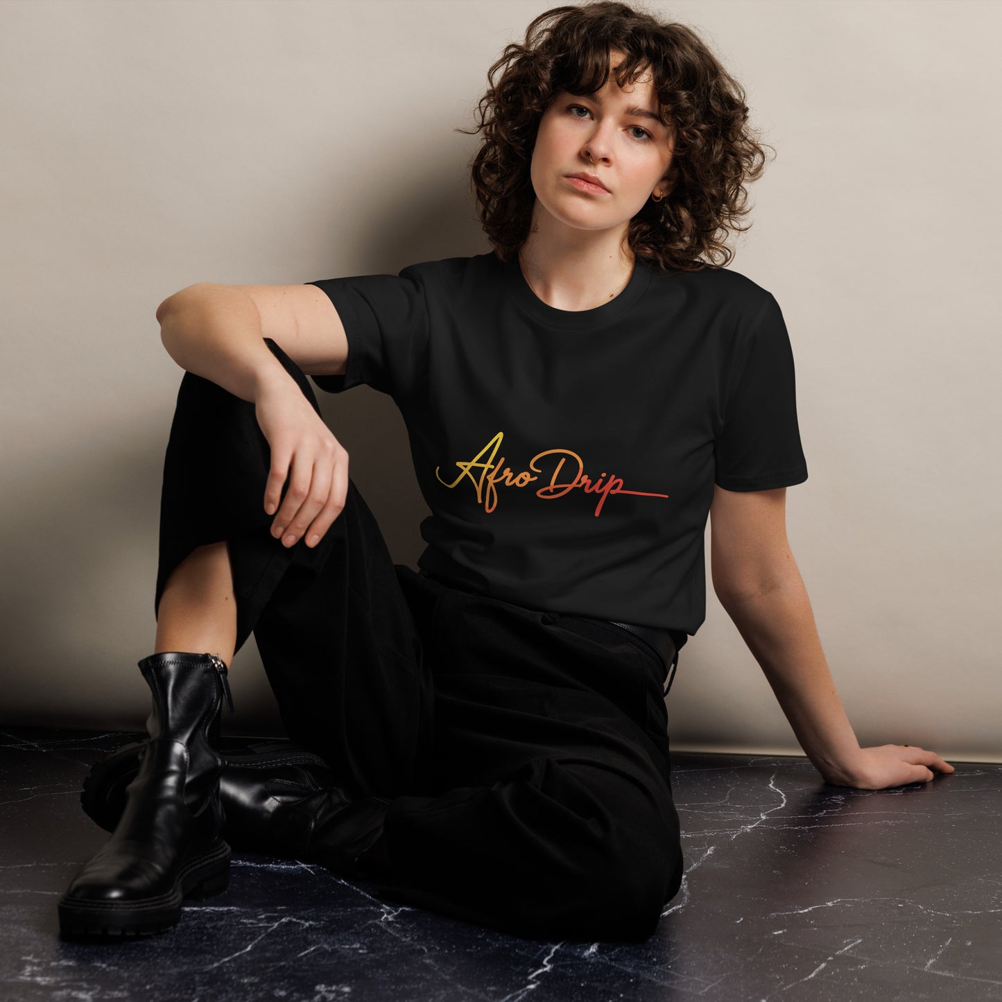 AfroDrip Unisex Premium T-Shirt in black, angled left-front view showing the AfroDrip logo graphic print