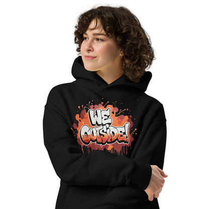 AfroDrip 'We Outside' Unisex Oversized Hoodie in black, angled front view showing dropped shoulders and oversized silhouette with graphic