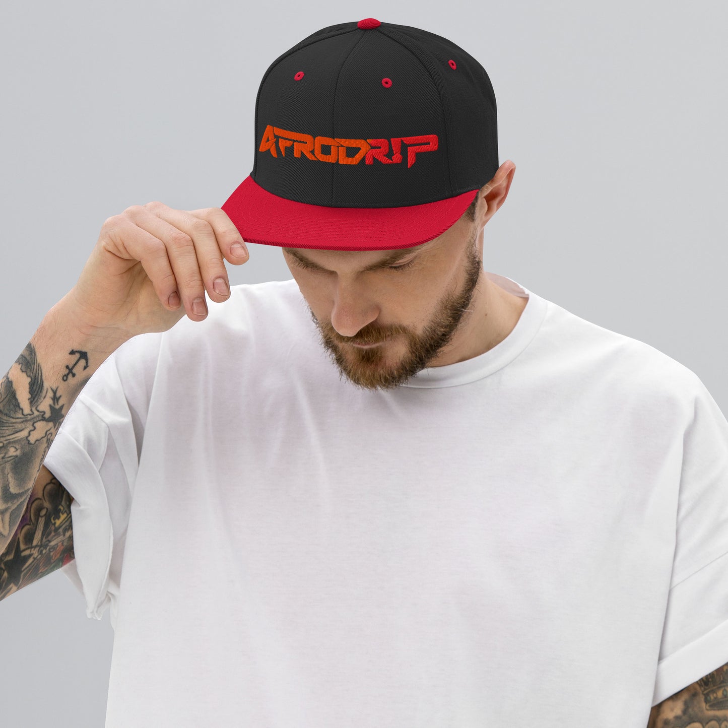 AfroDrip Classic Snapback Hat in black with red brim accent, front view showing embroidered AfroDrip logo