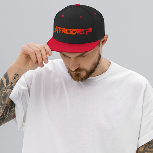 AfroDrip Classic Snapback Hat in black with red brim accent, front view showing embroidered AfroDrip logo