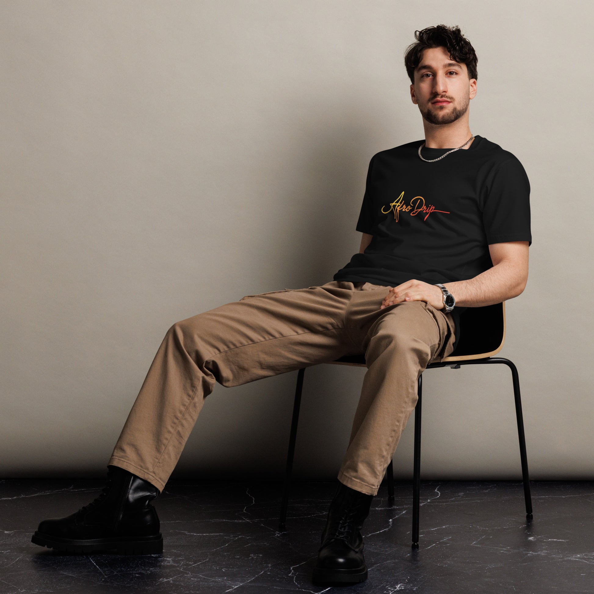 AfroDrip Unisex Premium T-Shirt in black, angled left-front view showing the AfroDrip logo graphic print